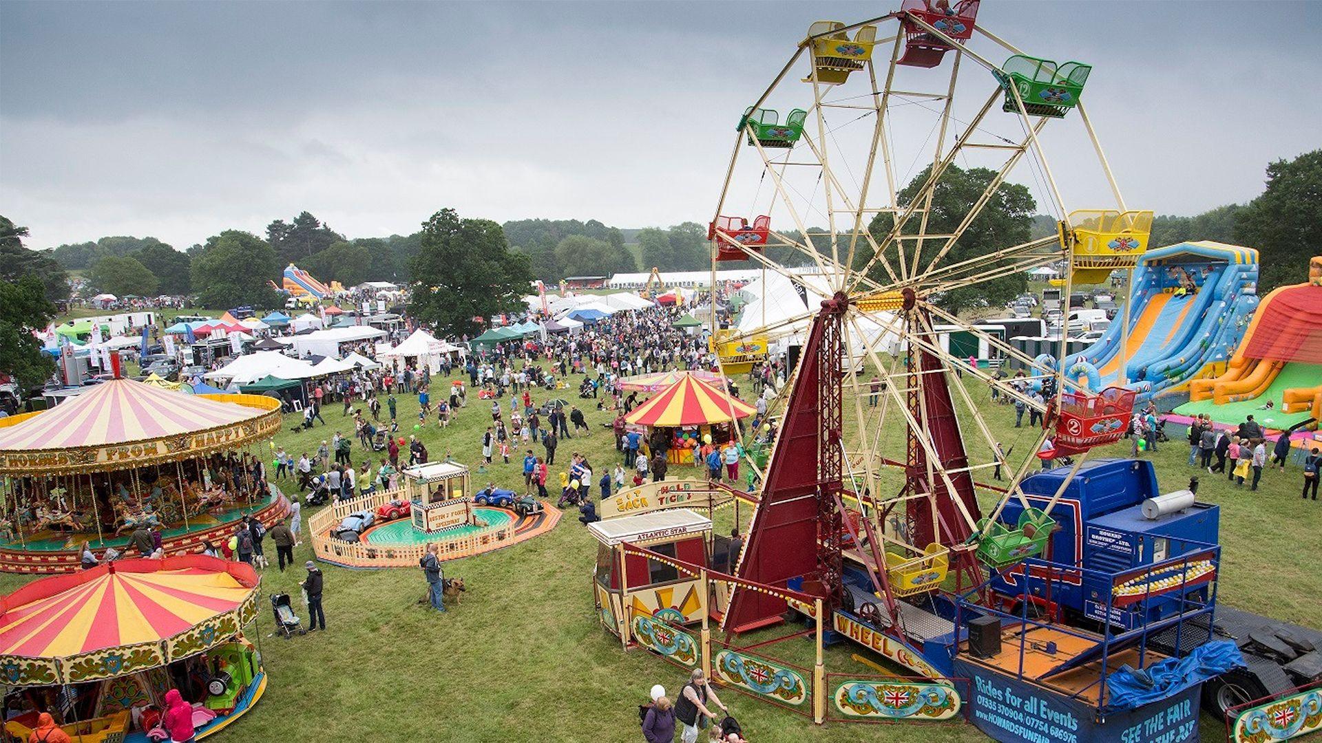 Aerial view of Derbyshire County show in previous years showing a ferris wheel, fairground and people on the field.