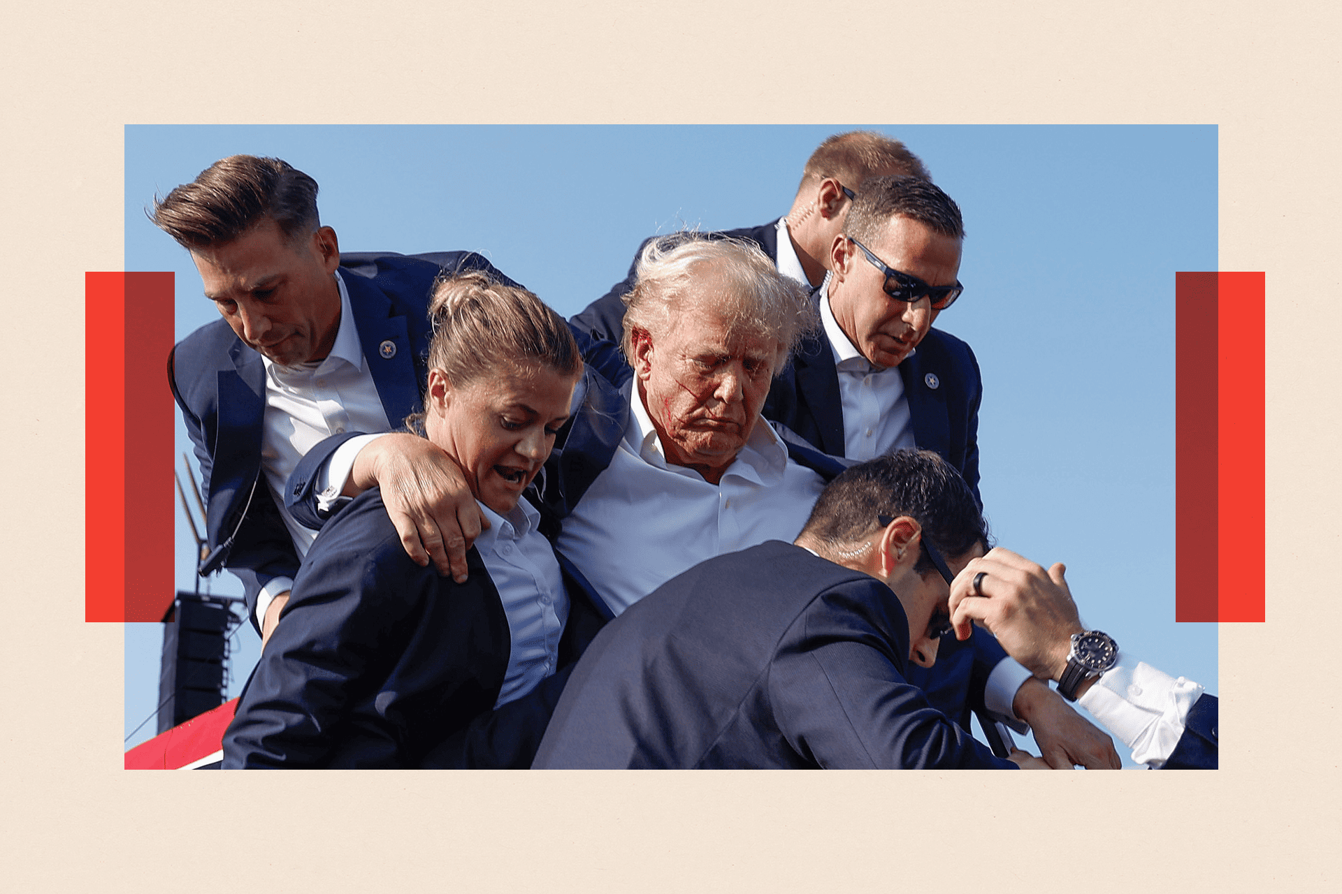 Donald Trump with blood streaked across his face, being helped by security 