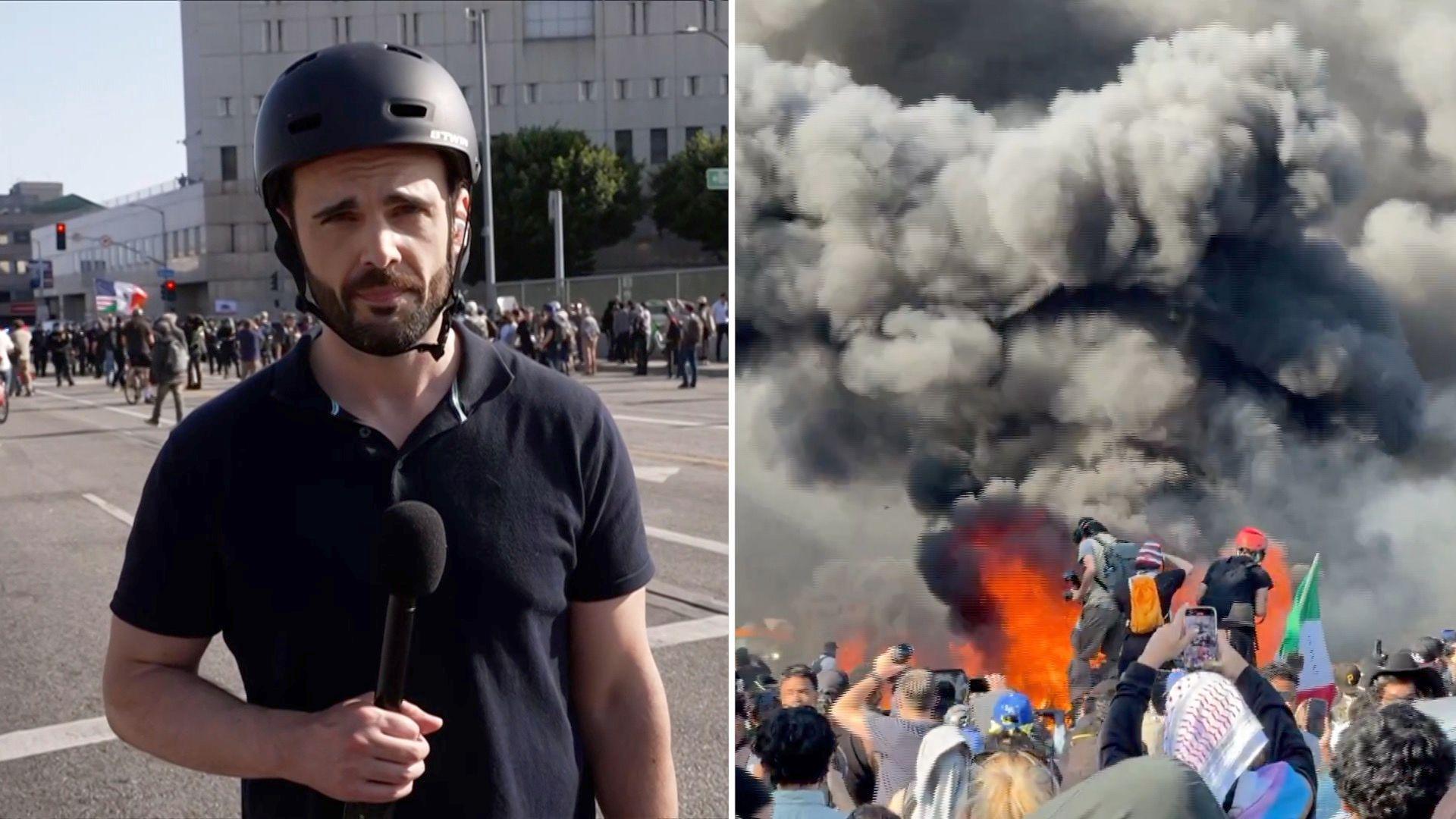 BBC's Carl Nasman is talking to a camera reporting on the immigration protests.
