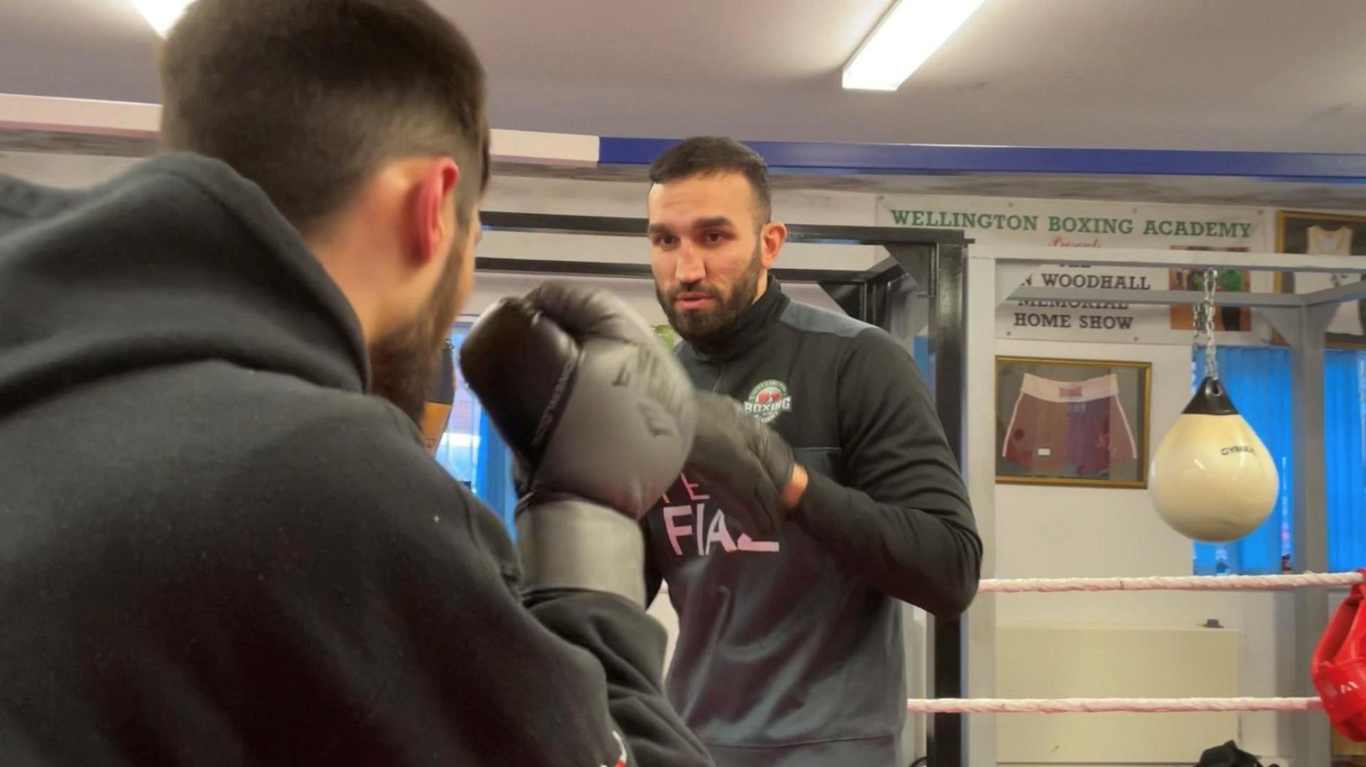 Boxer Harry Fiaz coaches a pupil