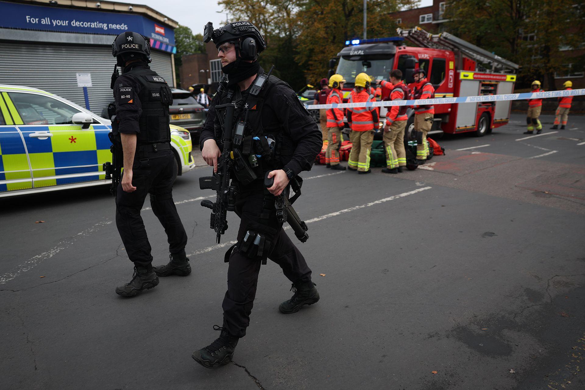 Police and first responders can be seen on the scene of a reported stabbing at a synagogue in Manchester.