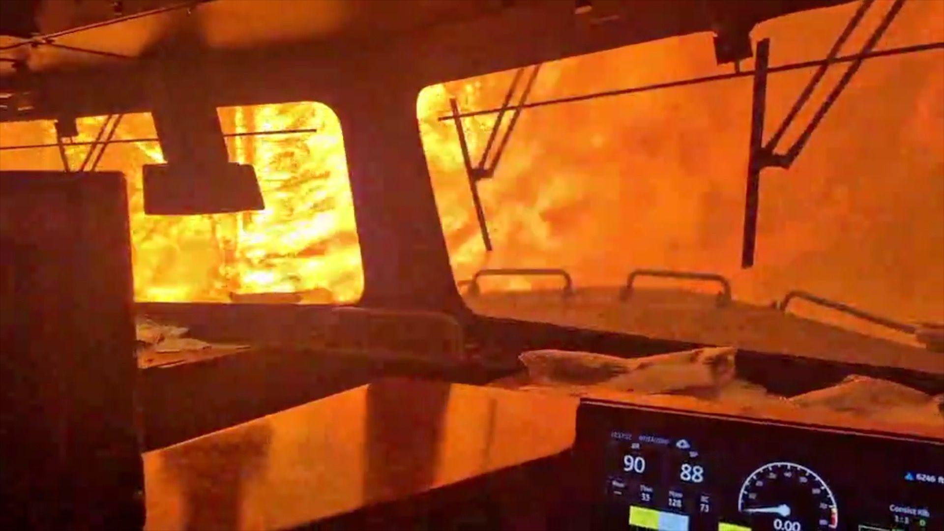 A train is surrounded by wildfire.
