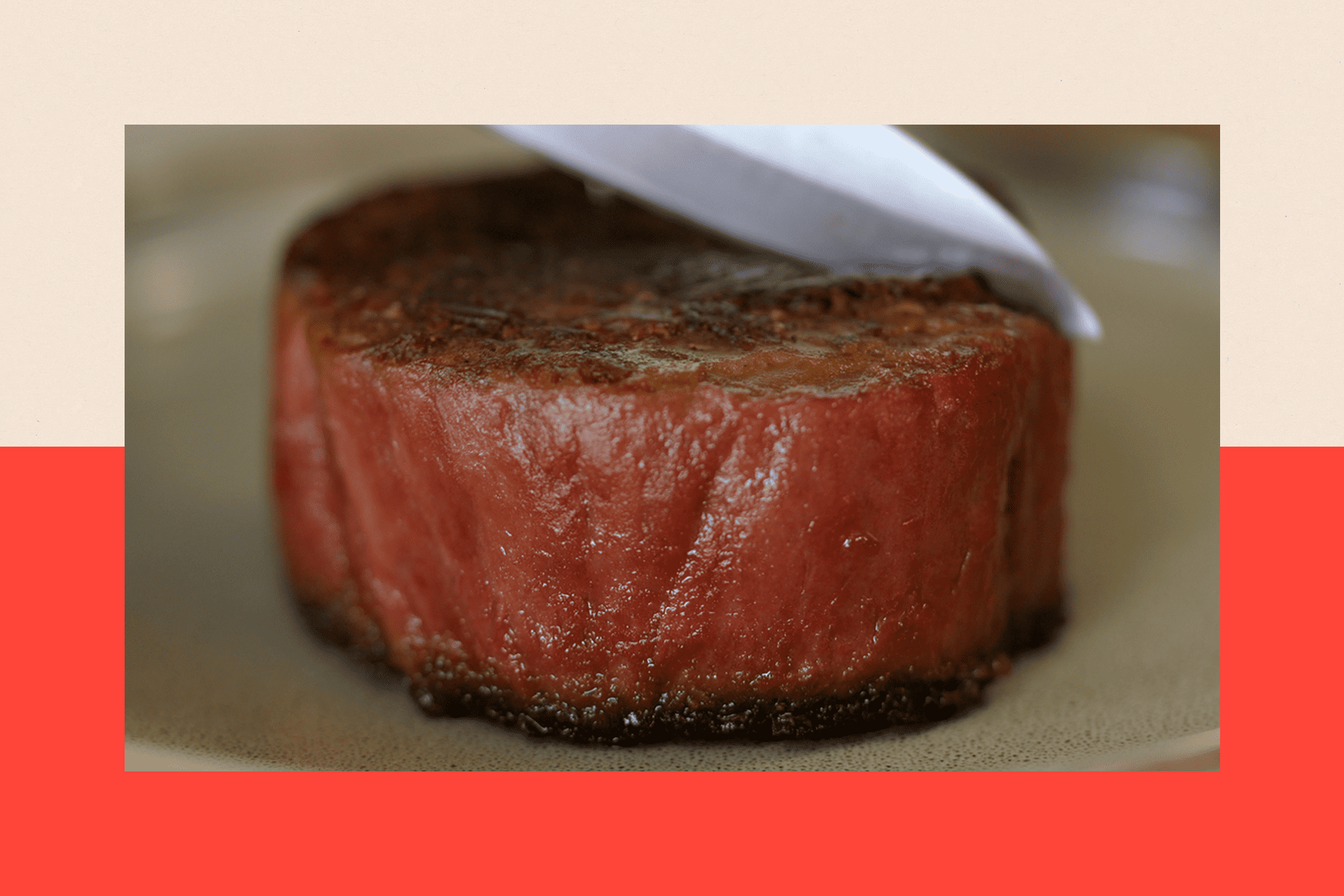 A knife slices into a lab grown steak