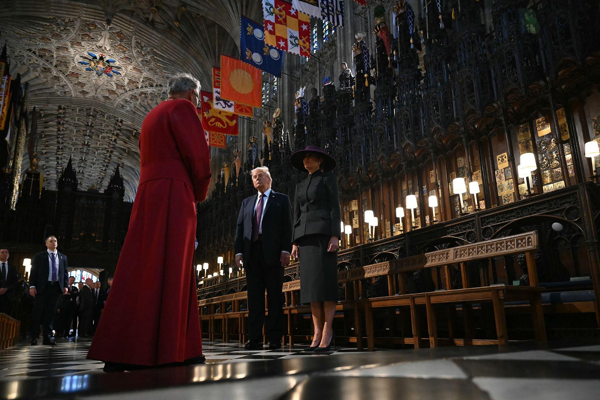 US President Donald Trump (C) and US First Lady Melania Trump (R) are taken on a tour of the quire St George's Chapel with Dean of Windsor Christopher Cocksworth (L) standing by at Windsor Castle on September 17, 2025 in Windsor, England. 