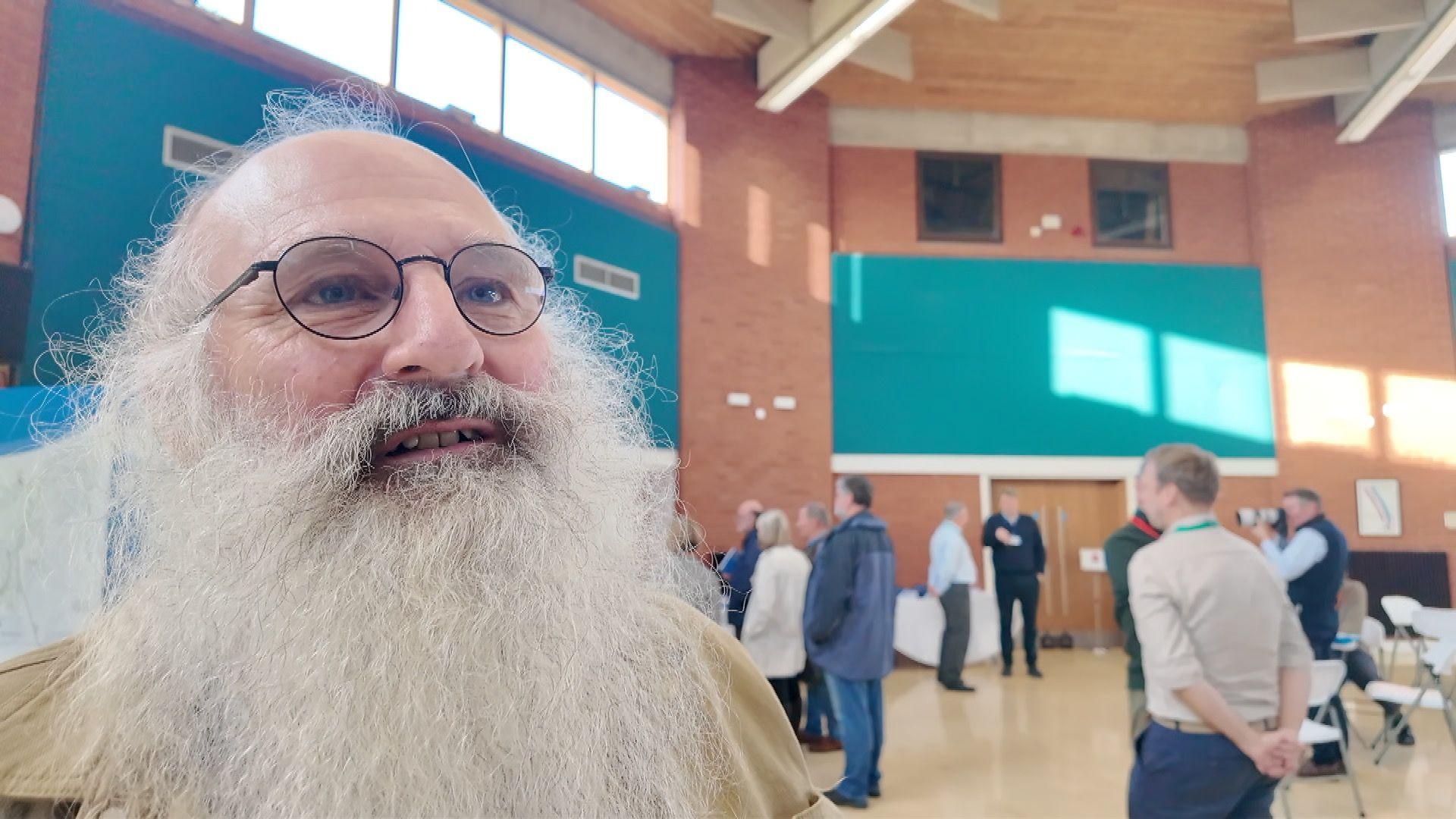 A man with a big grey beard and glasses is one of many who visited the reservoir exhibition
