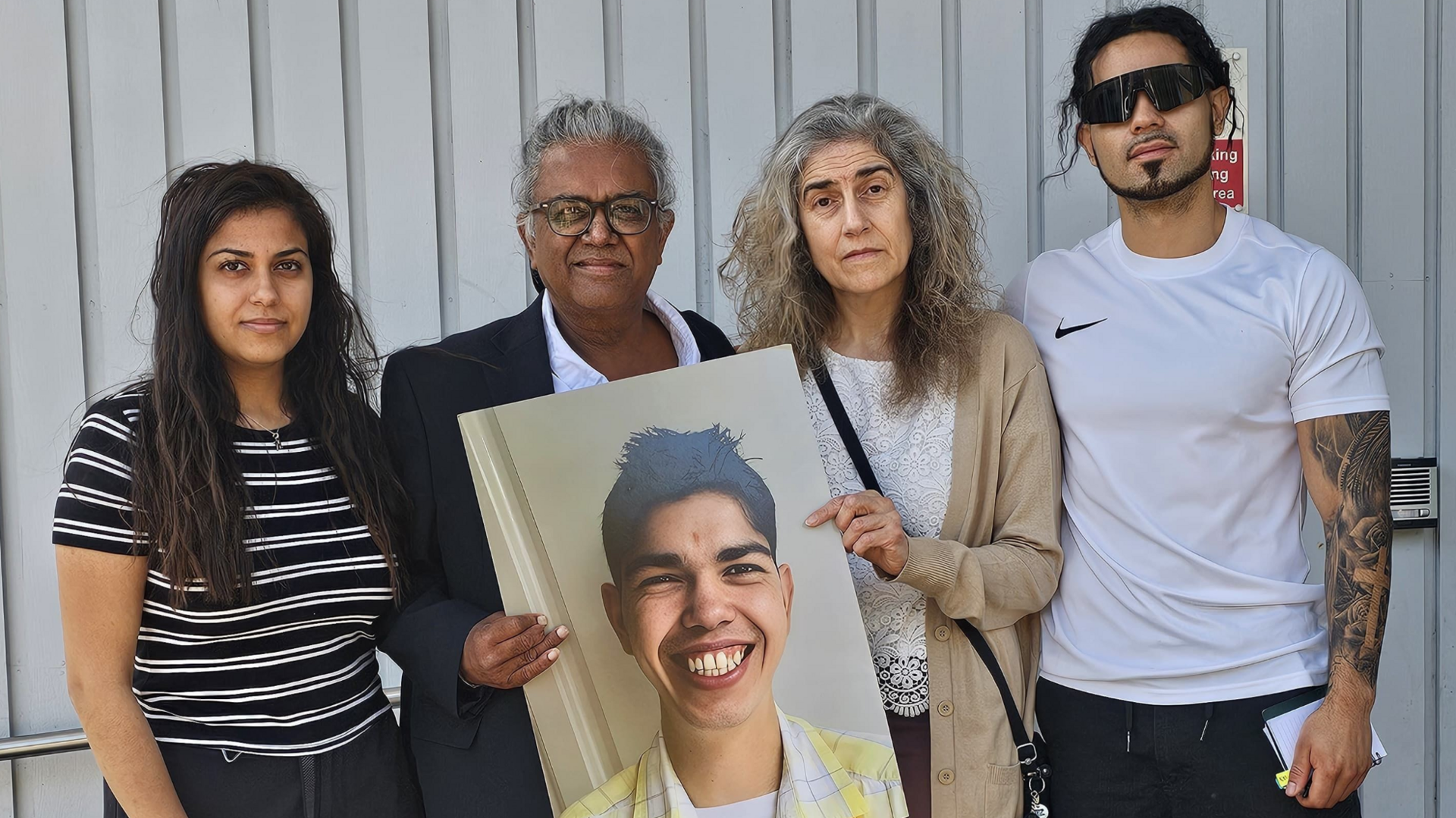 Description:The Patel family has vowed to challenge the coroner\'s findings in their son\'s death. Sister Umi and her partner flanking parents Jay and Louise Patel holding a photo of their late son Balram outside Southwark Coroner\'s Court