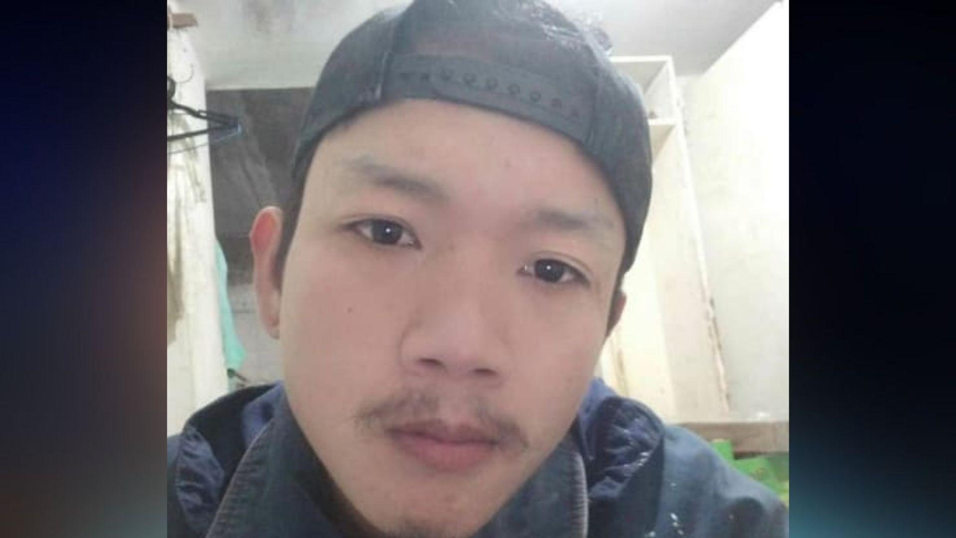 Sonthaya Akrasri pictured wearing a backwards baseball cap and a blue coat