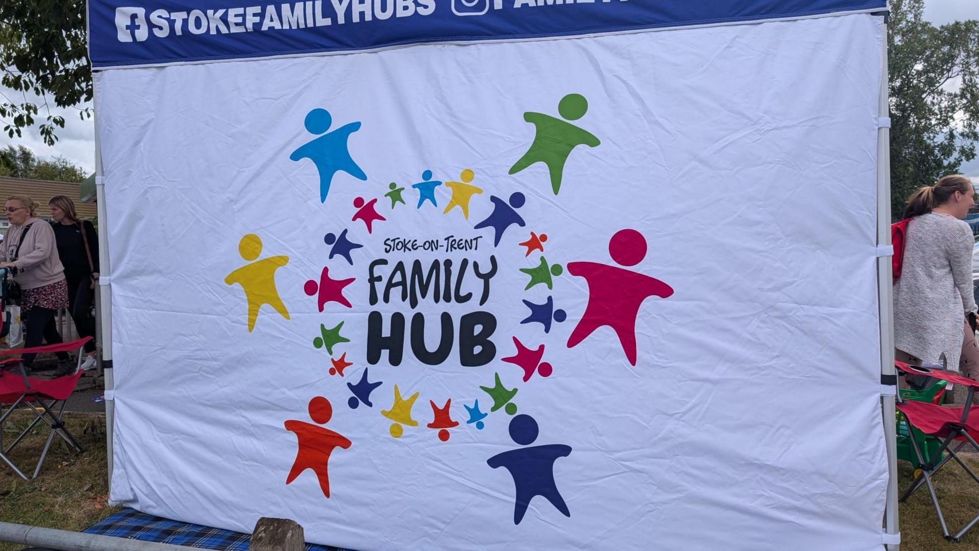 A bright and colourful gazebo with branding - it reads 'Stoke-on-Trent family hub'