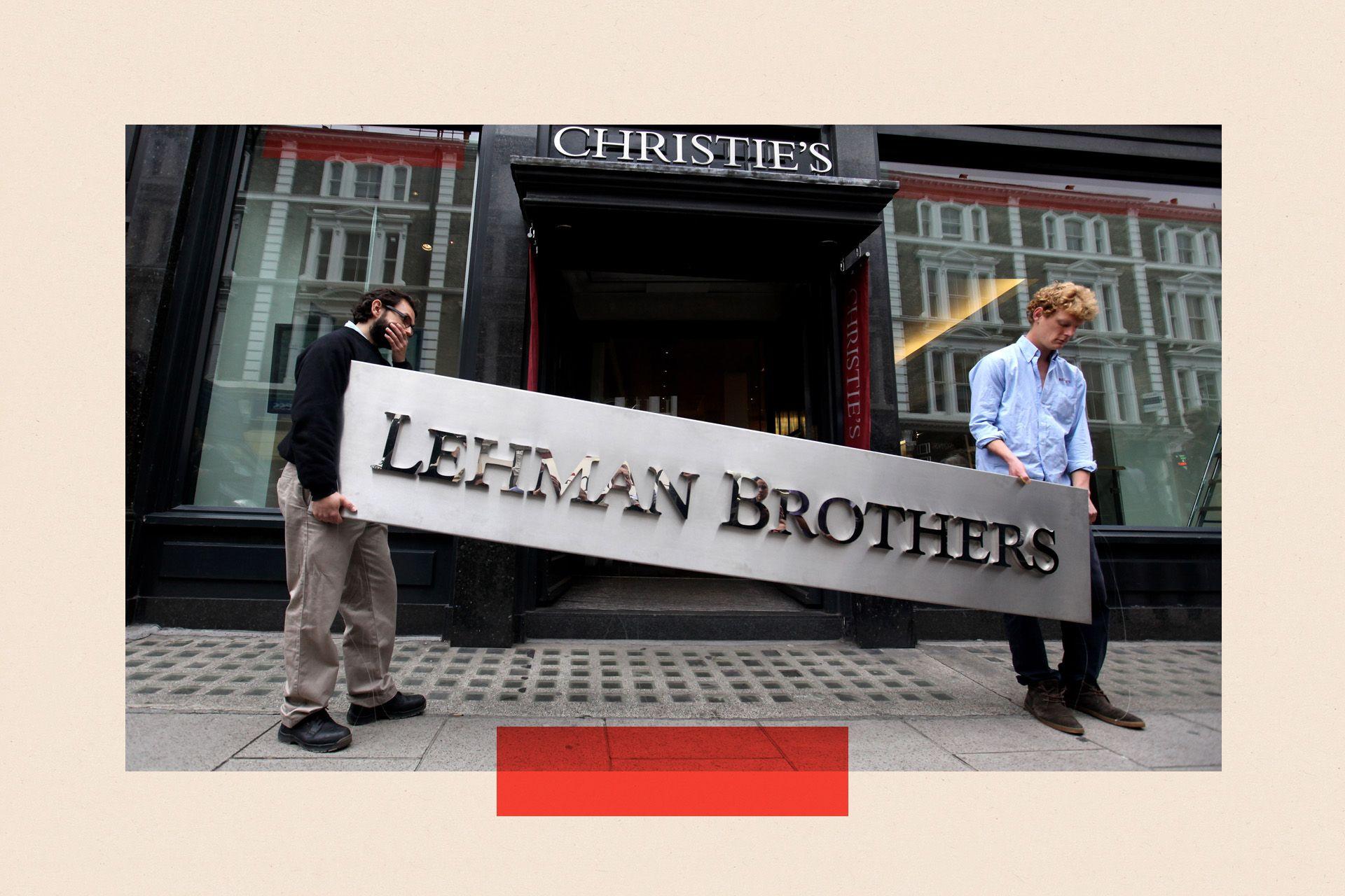 Two people outside Christie's auction house manoeuvre the Lehman Brothers corporate logo
