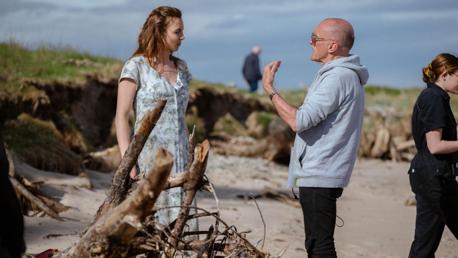 Jodie Comer in conversation with Danny Boyle on a beach