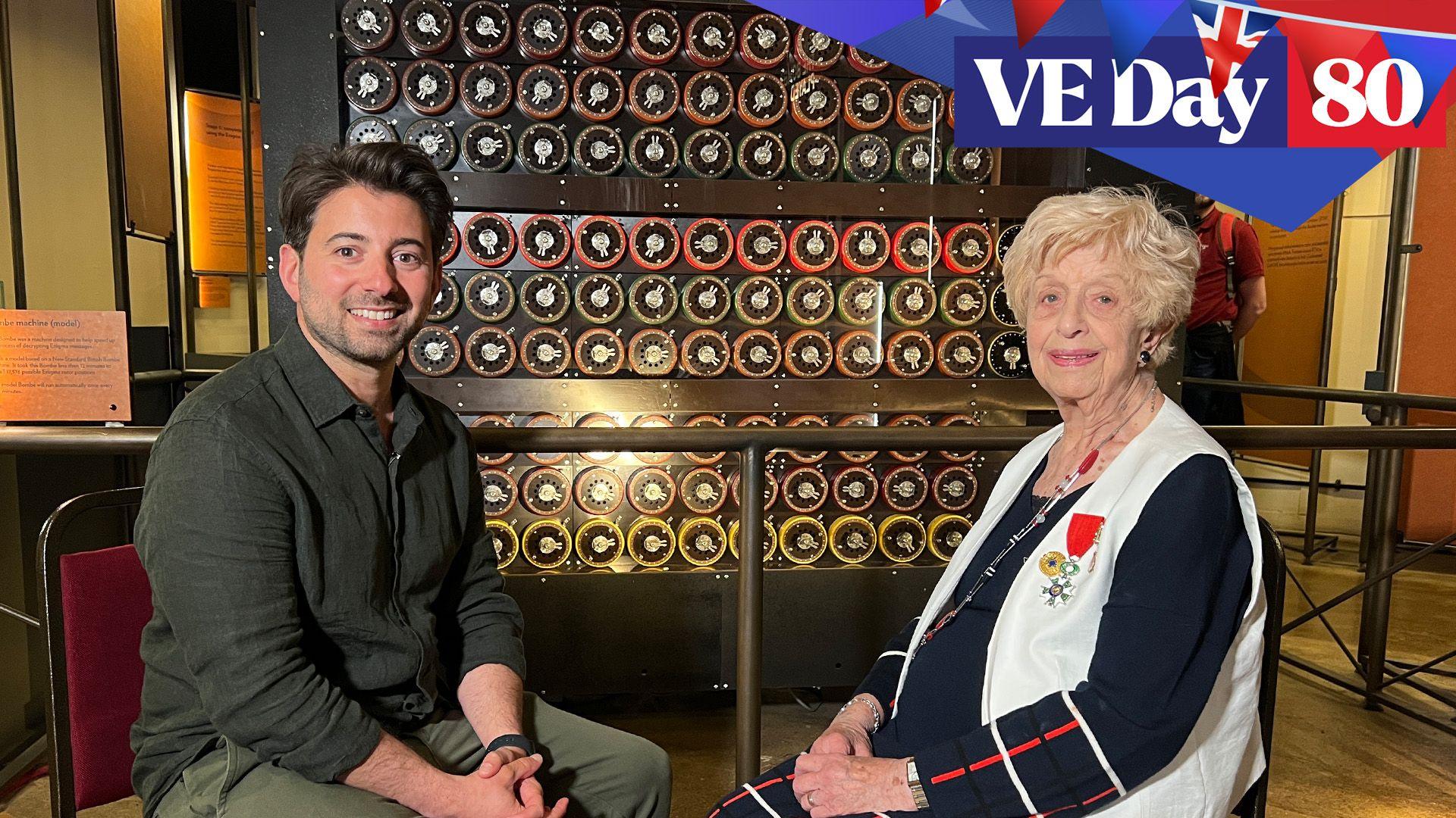 Ricky sits with Ruth Bourne in front of a Bombe machine replica