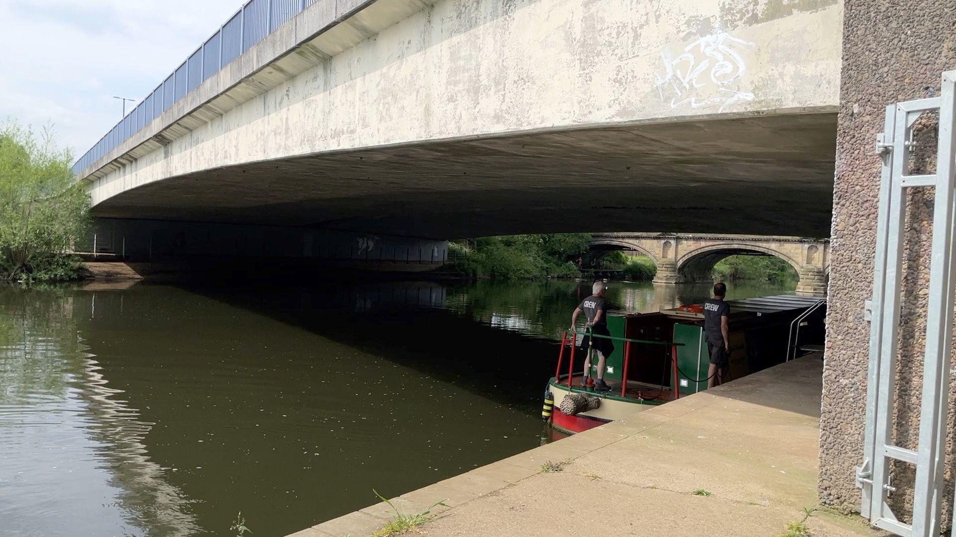 The boat moored under a bridge