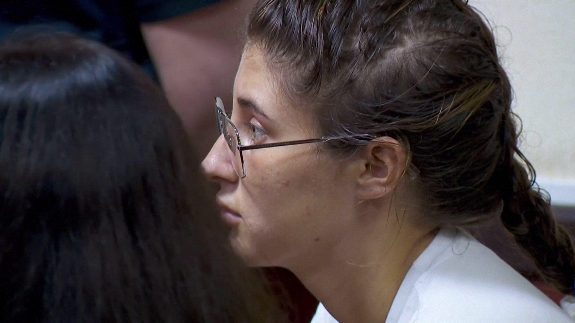The side profile of Bella Culley as she sat in court. She is wearing glasses with her hair in a French plait.