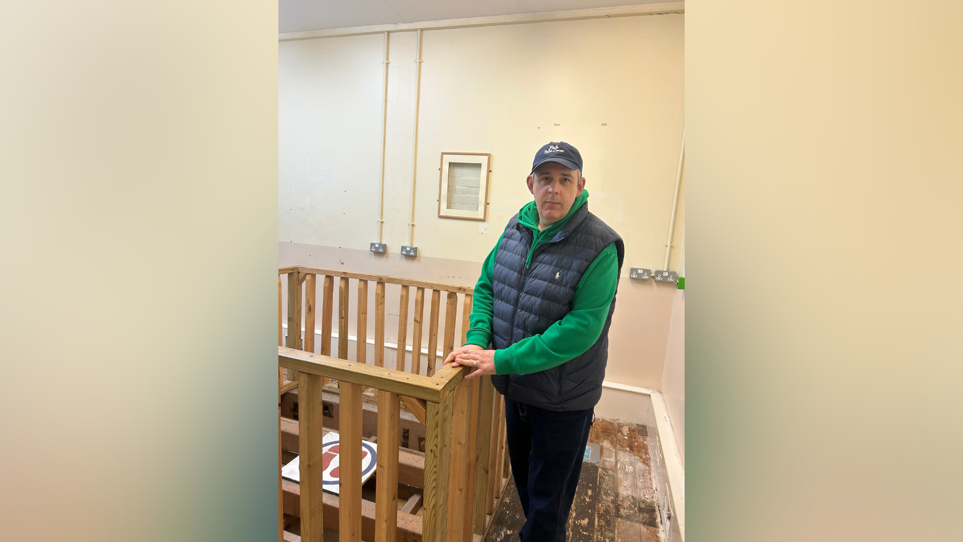 Paul Tool standing in what used to be a room in Shepton Mallet Prison where prisoners were executed. Next to Paul is a wooden gate surrounding the drop zone.
