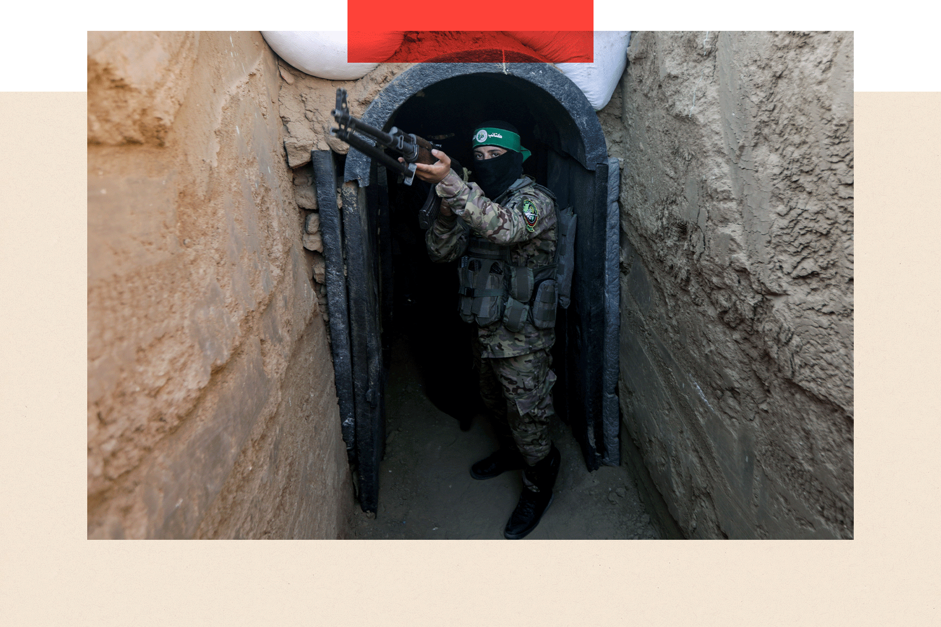 A fighter stands in front of a tunnel during an exhibition of weapons