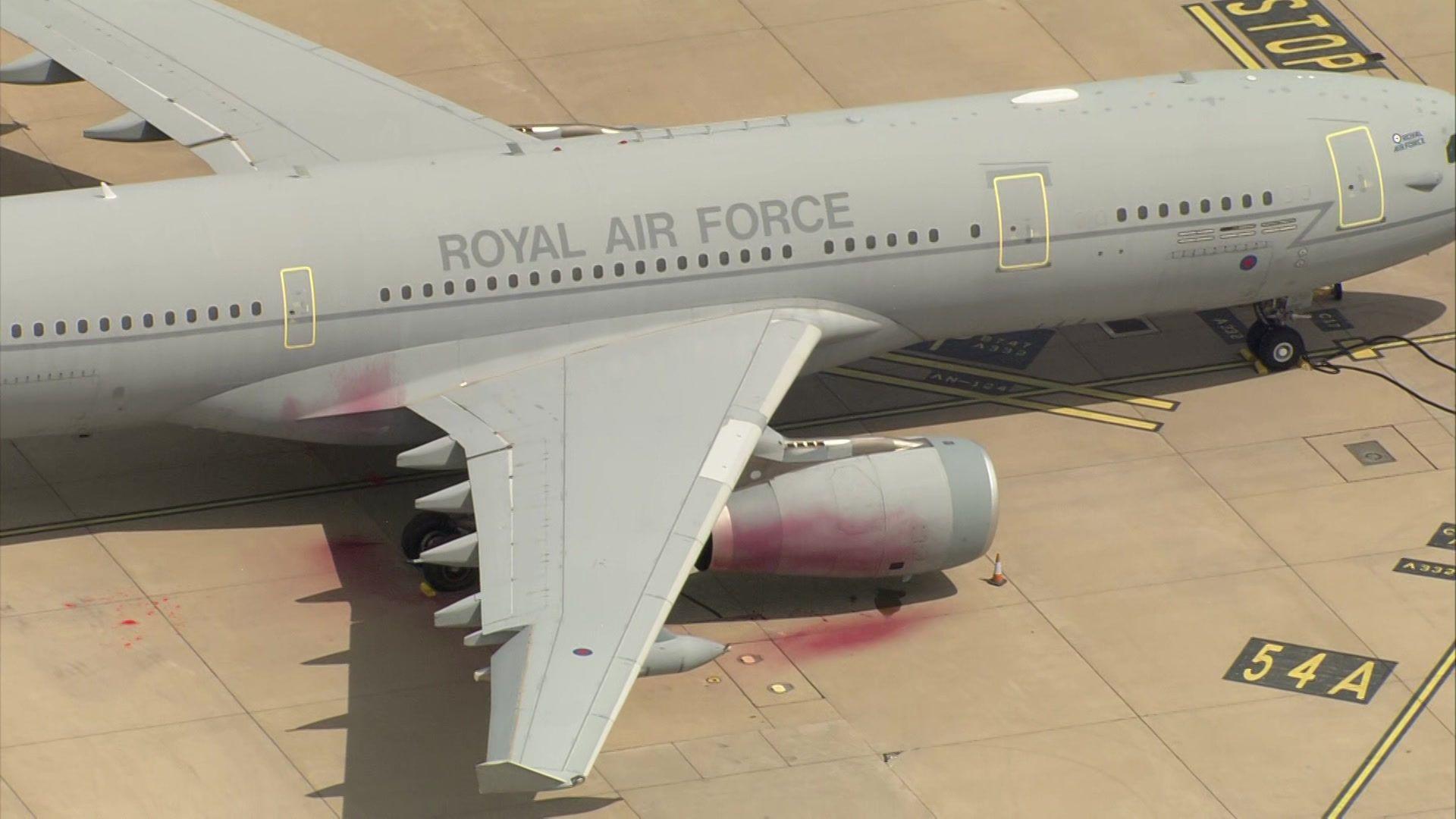 Red paint is seen on and around a Royal Air Force plane