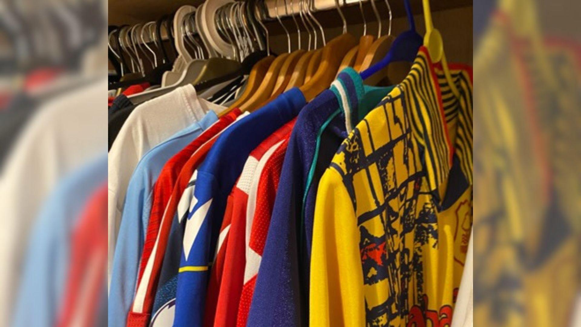 A row of football shirts on a clothing rail.