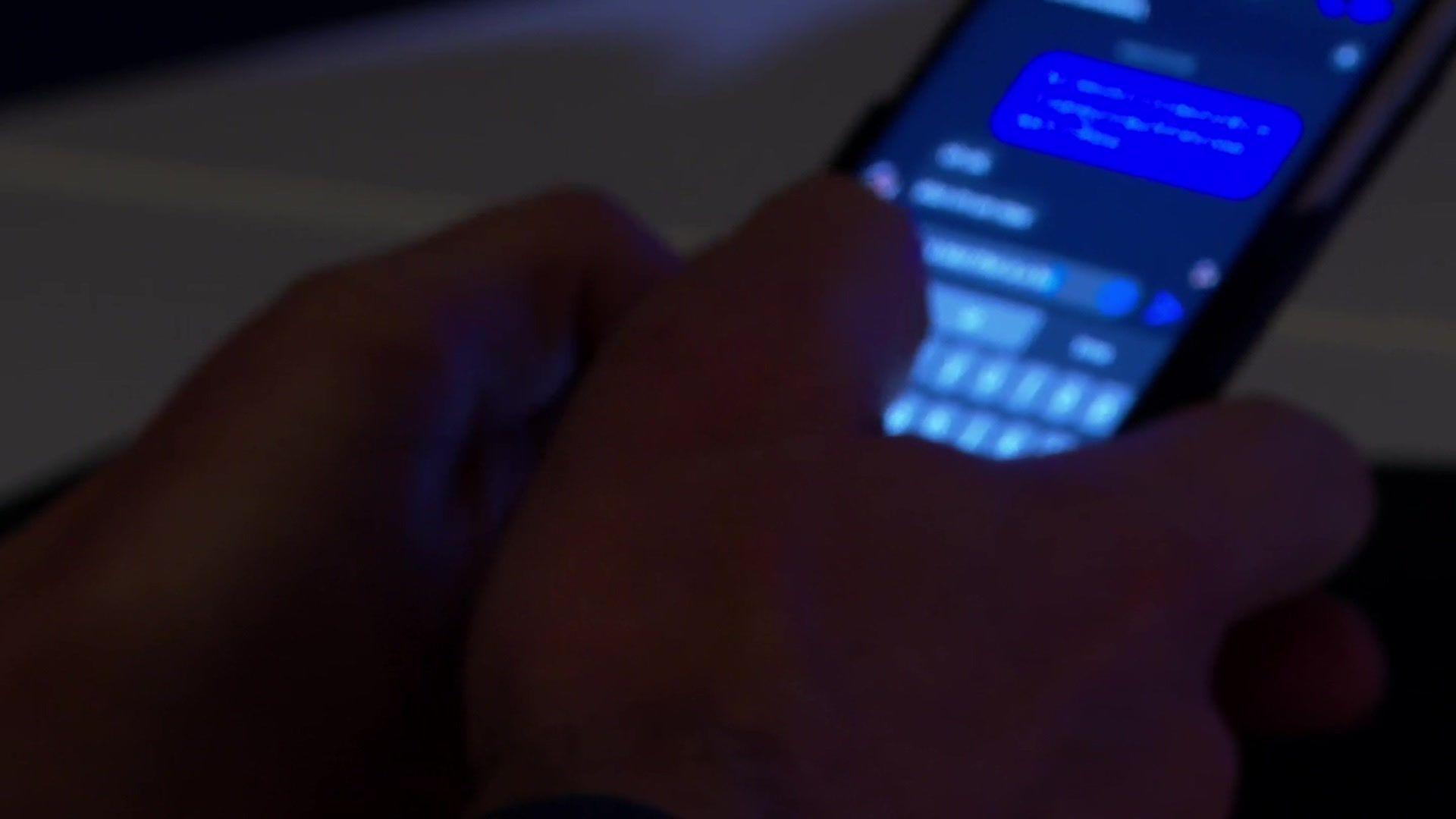 A close up of a pair of hands typing messages on a phone