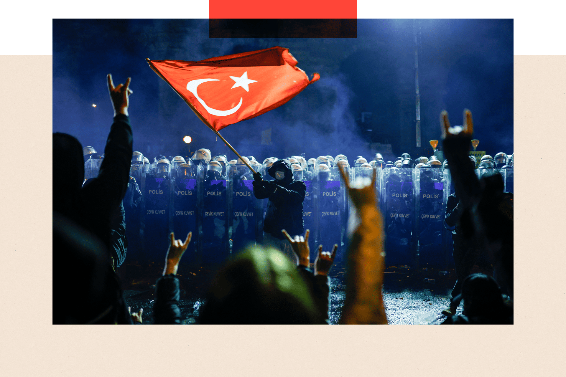 A protester waves Turkey's national flag before Turkish riot police