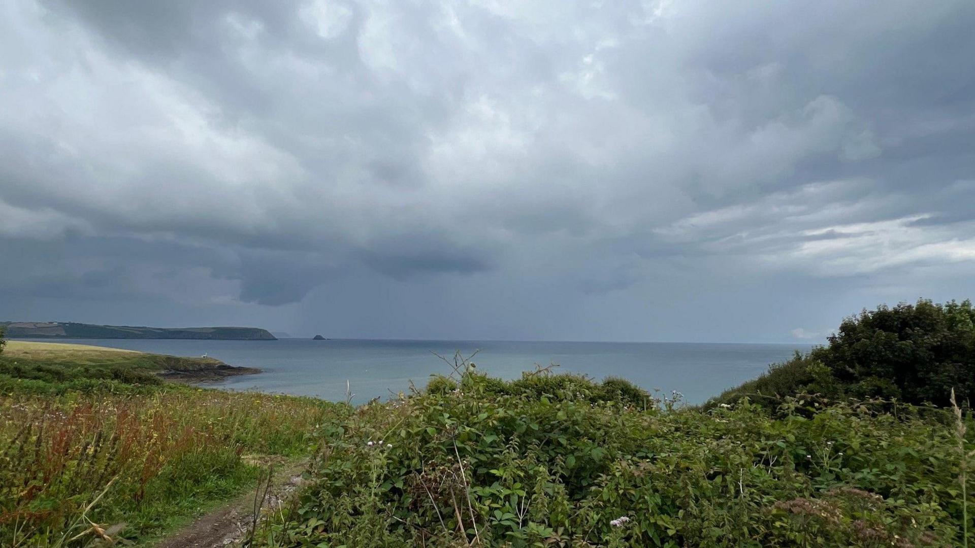 Coastal path with stormy clouds 