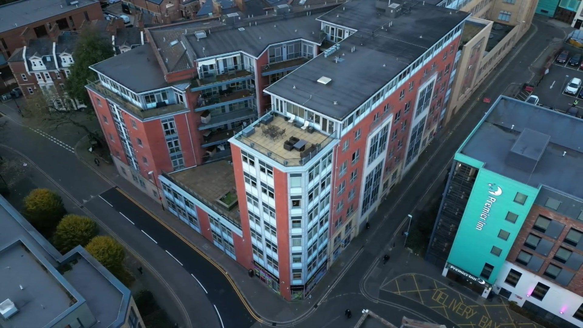 Aerial shot of the multi-storey apartment block Bloomsbury House, which is a mix of redbrick and white panels