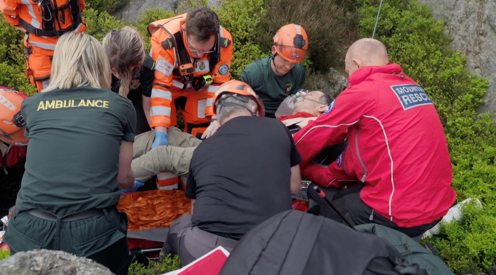 Paramedics and mountain rescue volunteers lift Mr Foxley onto a stretcher.