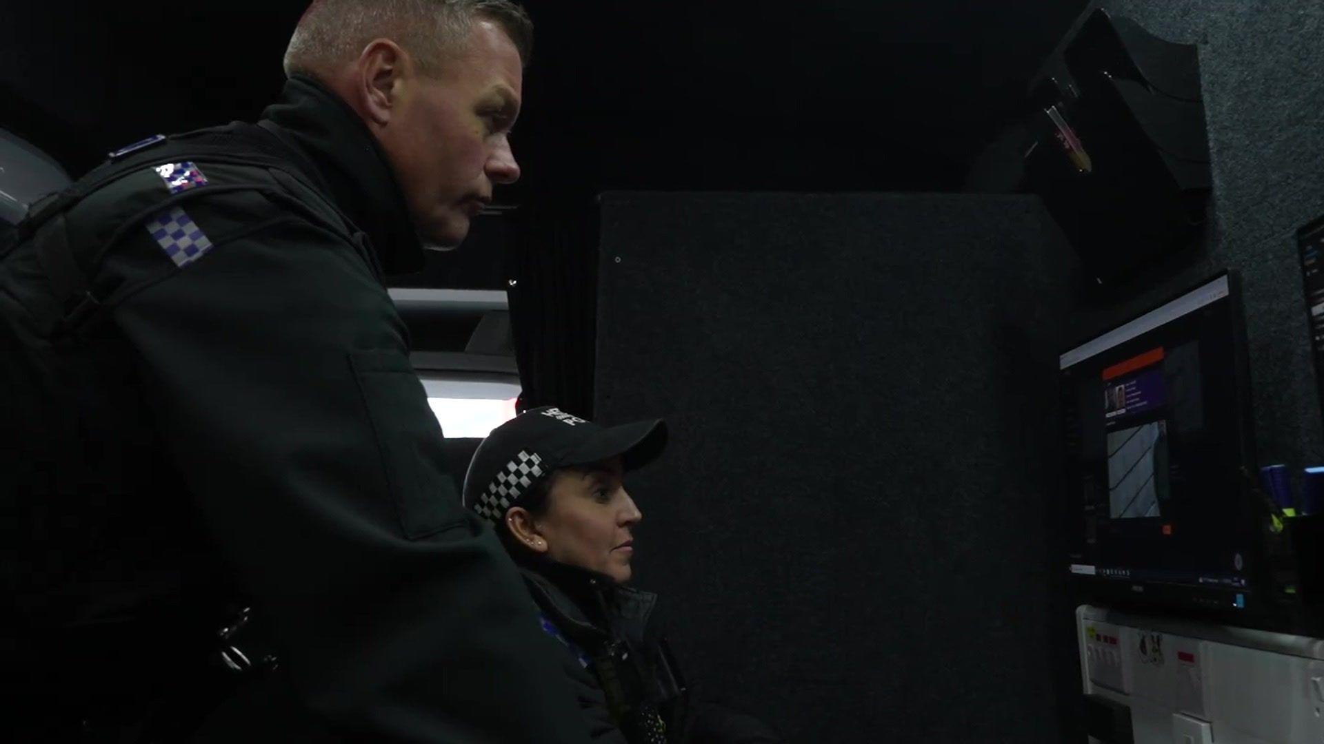 Police officers inside a live facial recognition van