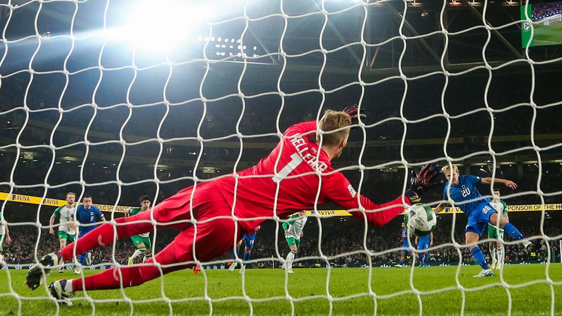 Caoimhin Kelleher gets across to save Joel Pohjanpalo's penalty at the Aviva Stadium