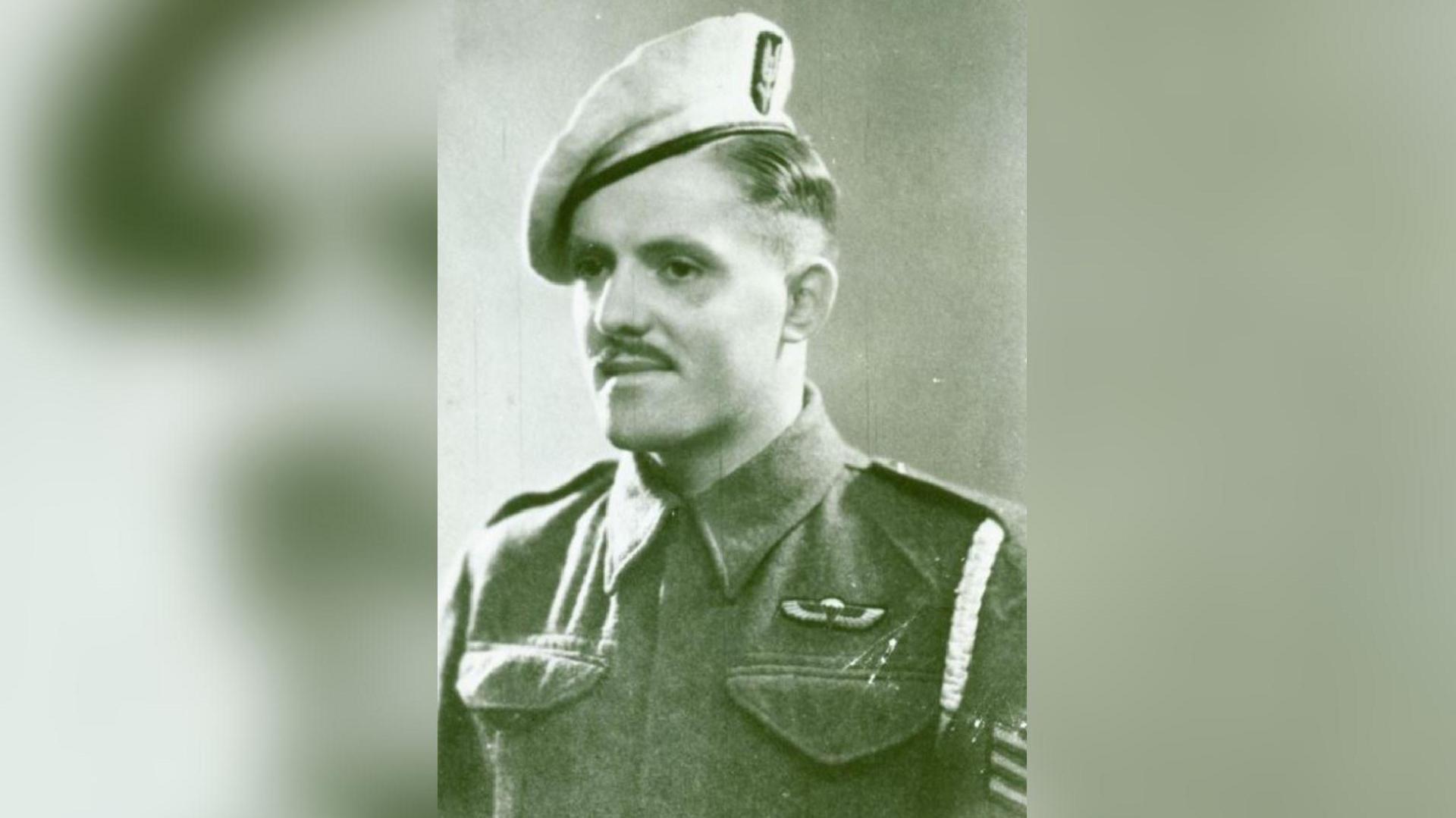 John Almonds pictured during World War Two in his Army uniform, including sergeant stripes and SAS beret. He has a short moustache and has dark hair.