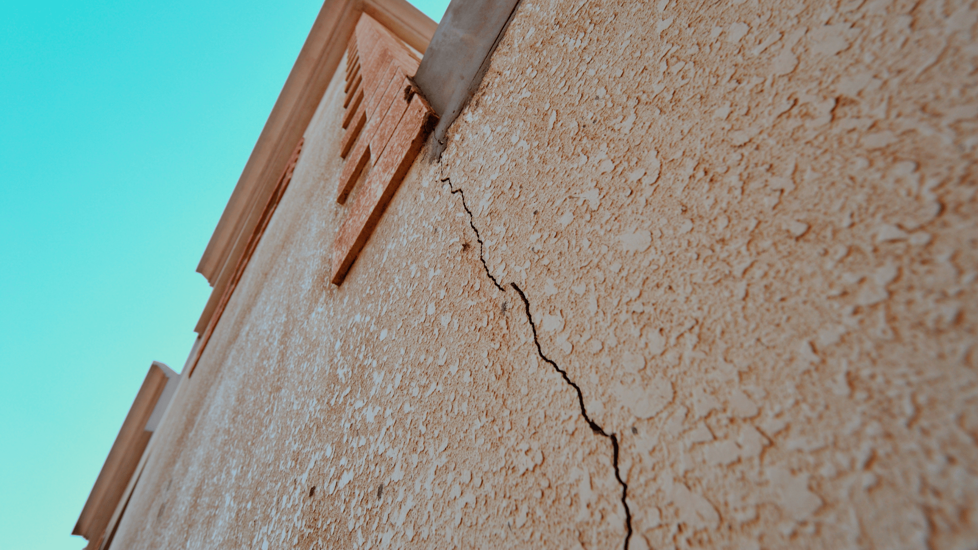 image shows a crack appearing on a house