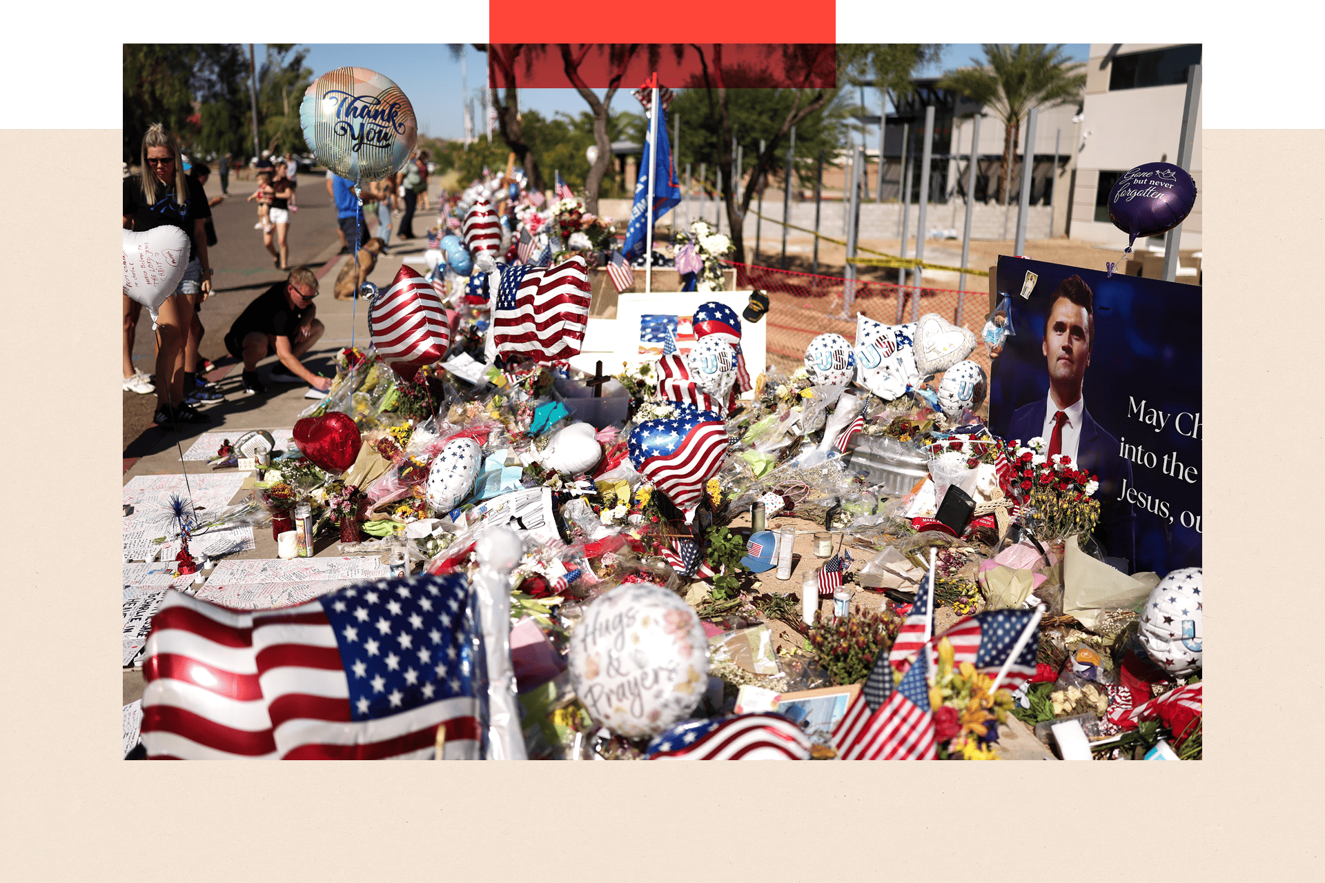 People gather at a makeshift memorial for Charlie Kirk outside of the Turning Point USA headquarters in Phoenix, Arizona