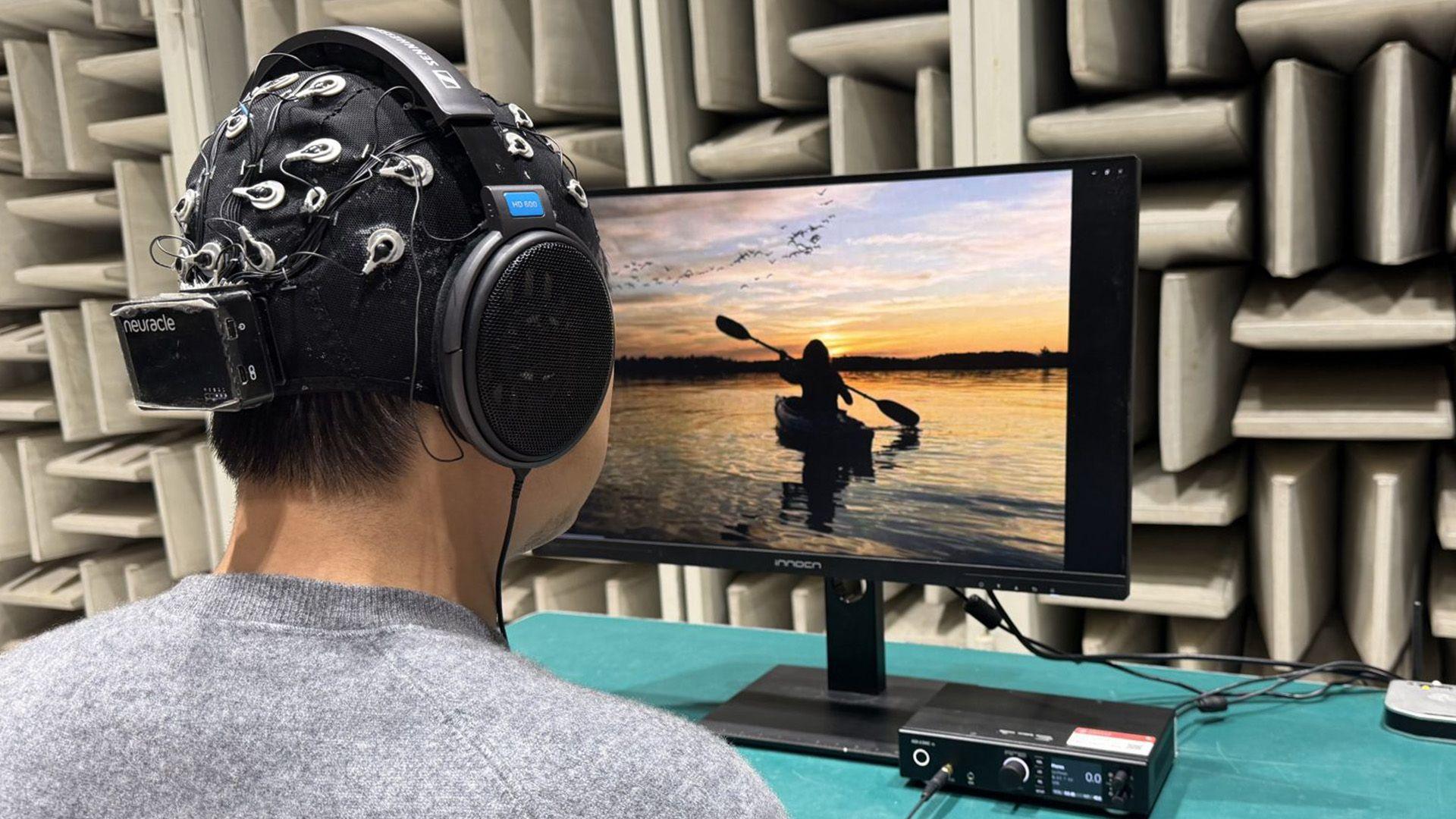 A participant views an image of a canoe paddling while listening for a splashing sound