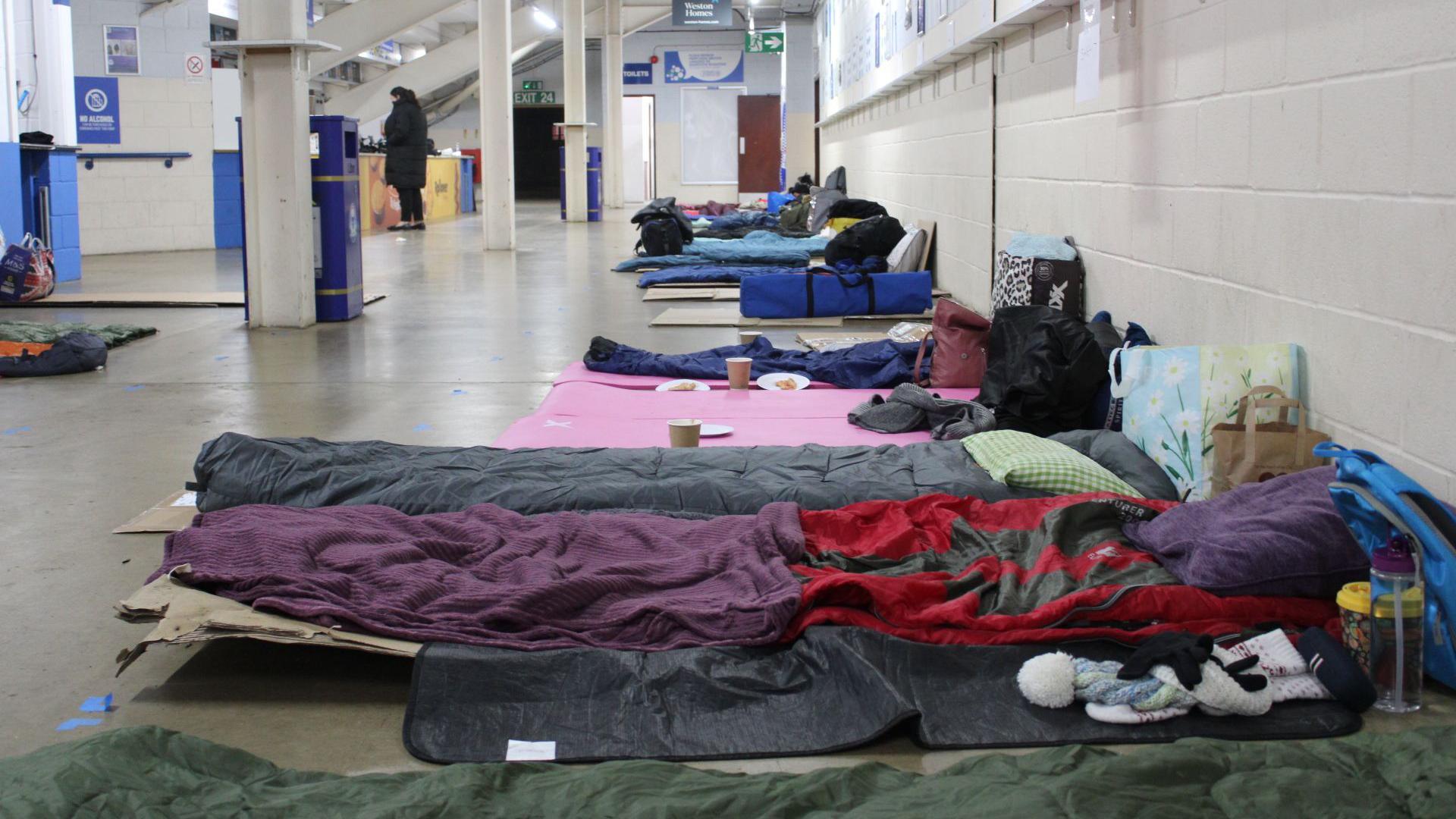 Bedding laid out on the concourse inside one of the stands at Peterborough United FC's stadium