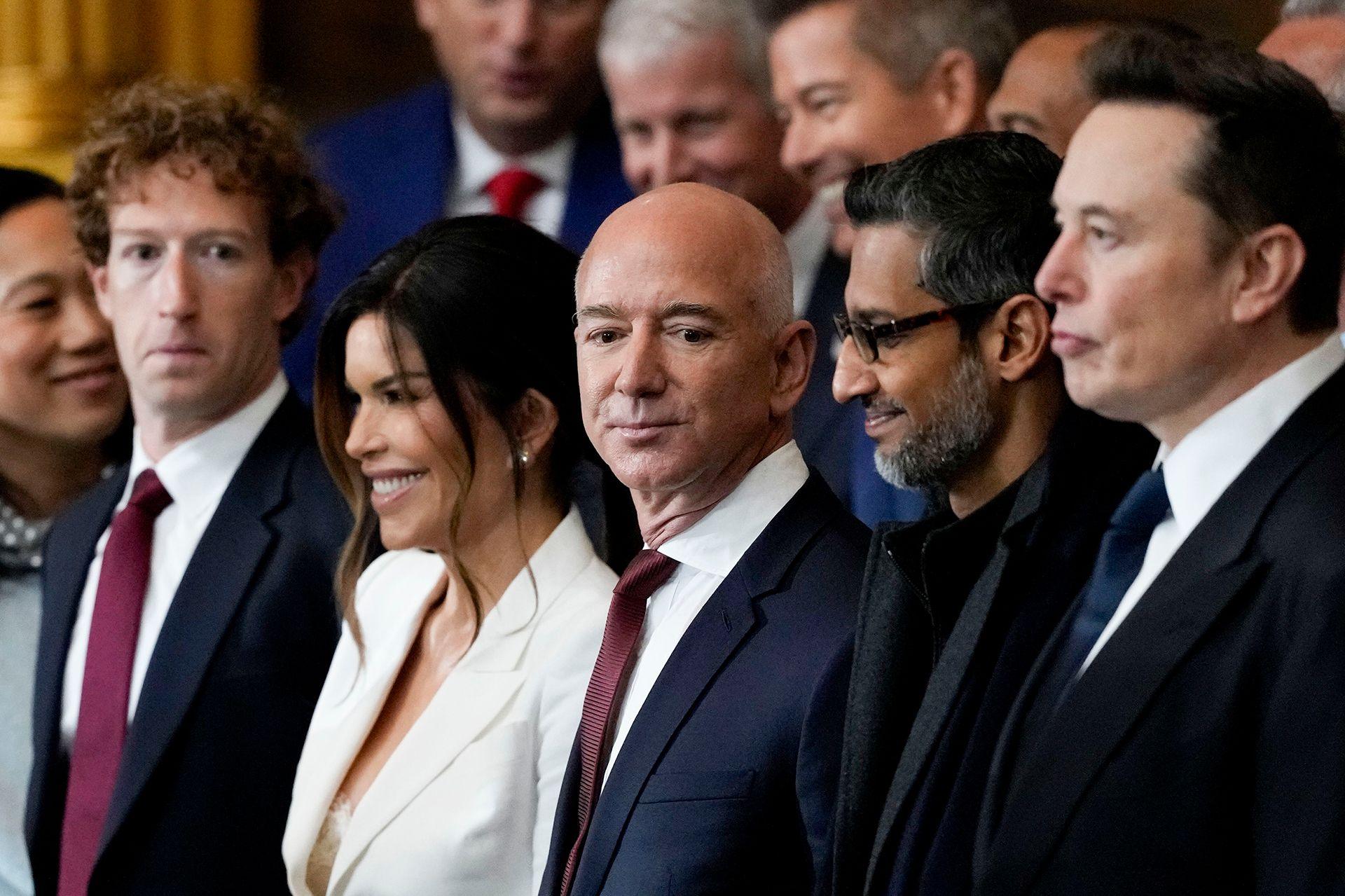 A photo of five people, smartly dressed in suits, standing in a line during the 60th presidential inauguration in the rotunda of the US Capitol in Washington DC.