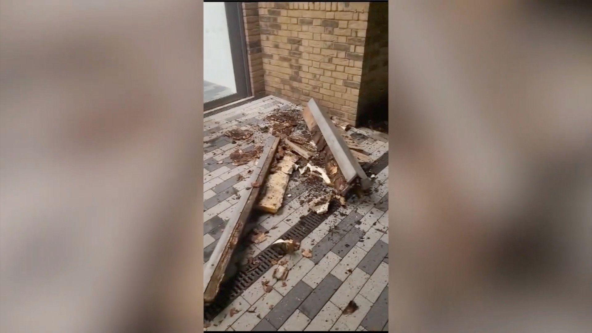 Piles of shattered wood and balcony fragments lie scattered on a private terrace, metres from the Surowka family's windows, where a mother and two children were sitting when the structure collapsed.