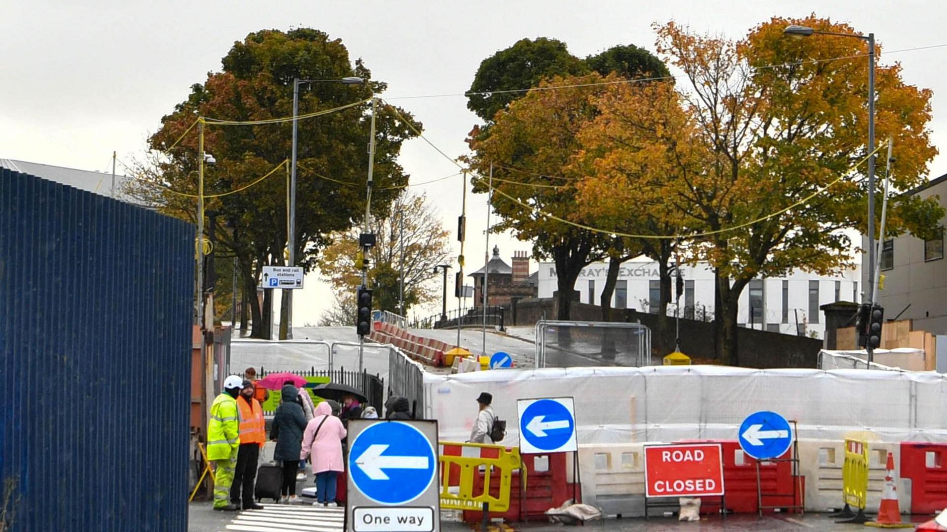 View of Boyne Bridge from Grosvenor Road side. A barrier and 'road closed' sign are blocking it off. Workmen and pedestrians are to the left.