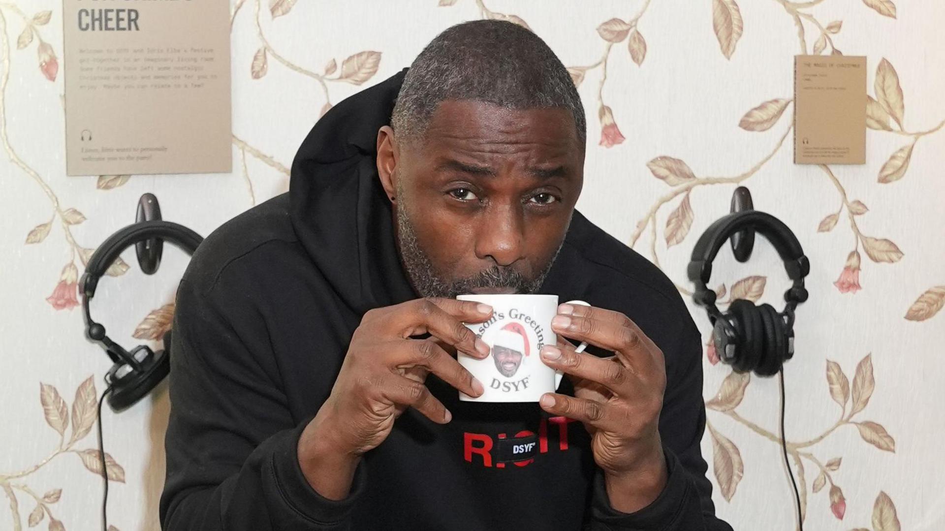 Idris Elba sipping from a mug at the launch of his Don't Stop Your Future pop-up at Truman Brewery in Shoreditch, east London.