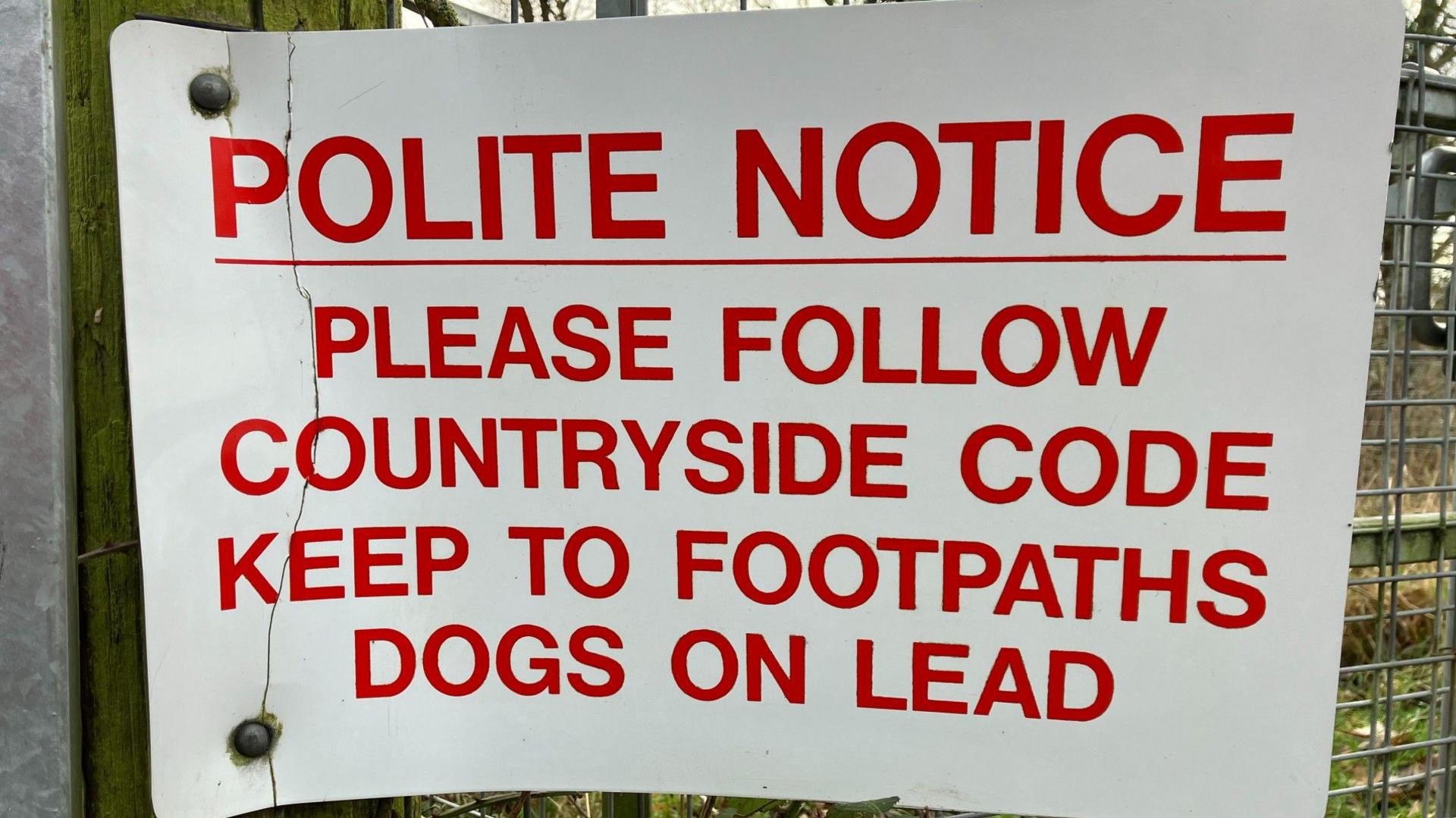 Sign on farm gate asking owners to keep dogs on leads