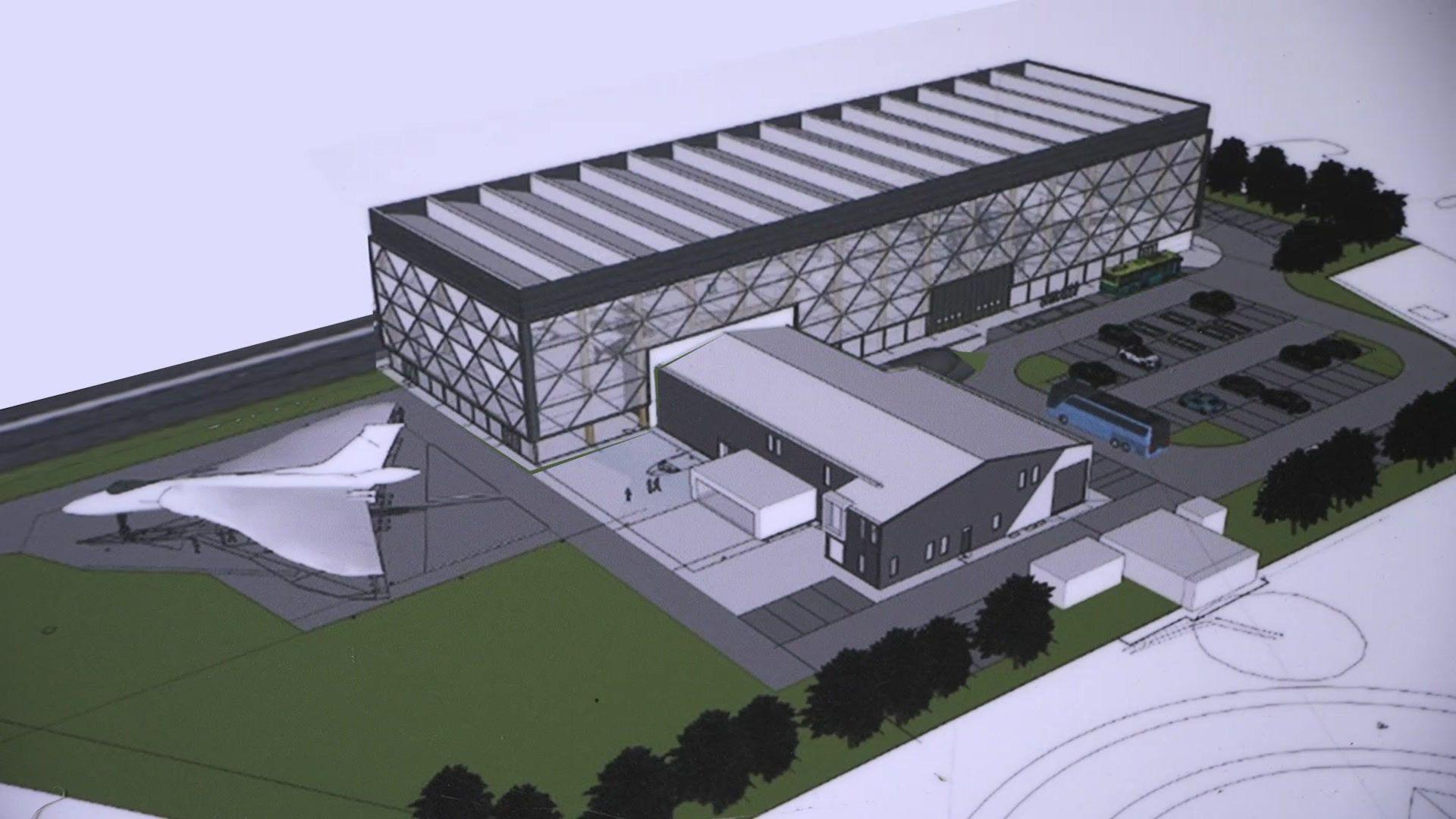 Computer generated image showing a large aircraft hanger and museum with parking