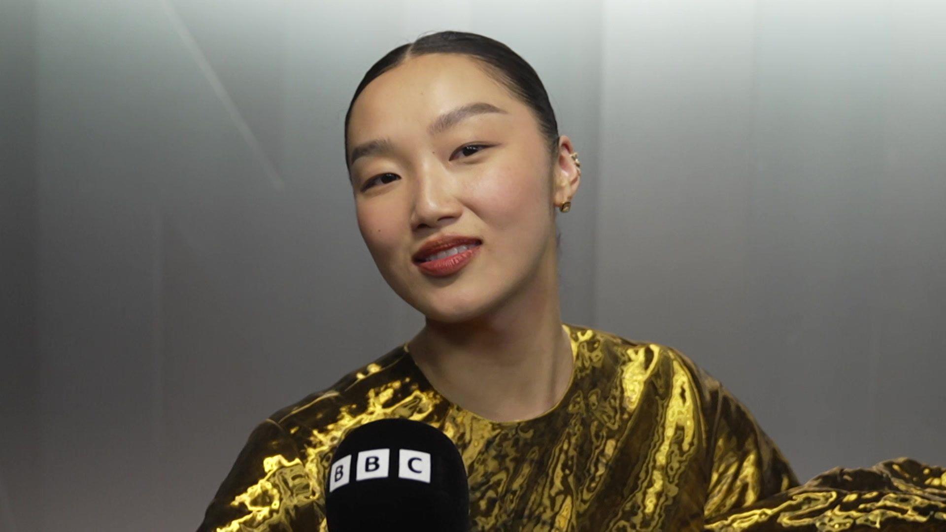 Audrey Nuna in a gold top