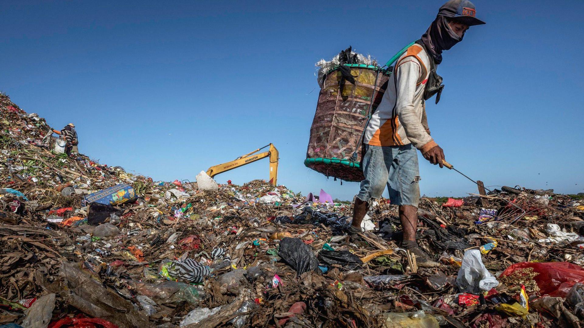 Scavengers searches for items and plastics to sell for recycling at Rawa Kucing landfill in Tangerang, Banten province, Indonesia 