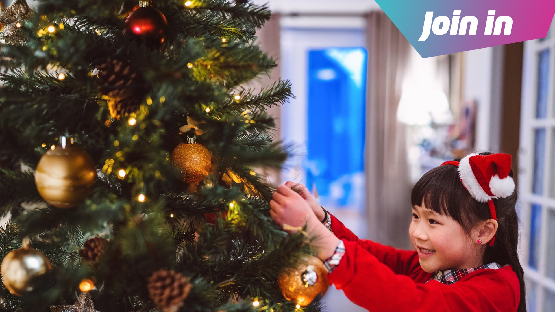 Young girl decorates Christmas Tree 