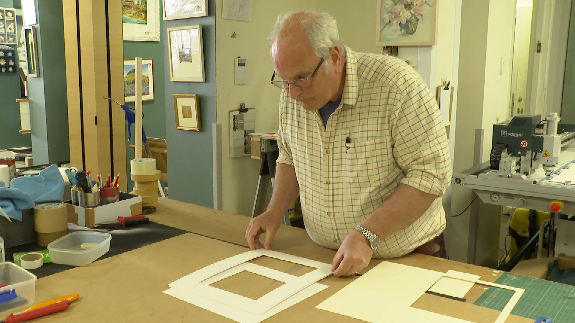 Steve Fussell, owner of Studio 4 Street in Totnes, putting together a picture frame in his workshop the rear of his store
