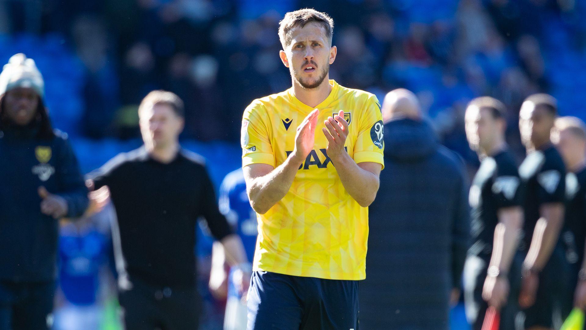 Will Vaulks of Oxford United applauds supporters