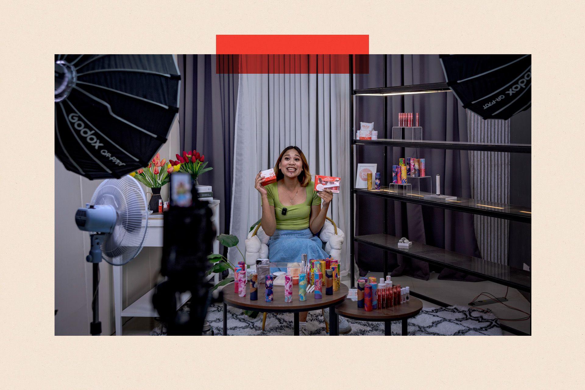 Image of someone selling colourful products in front of a camera