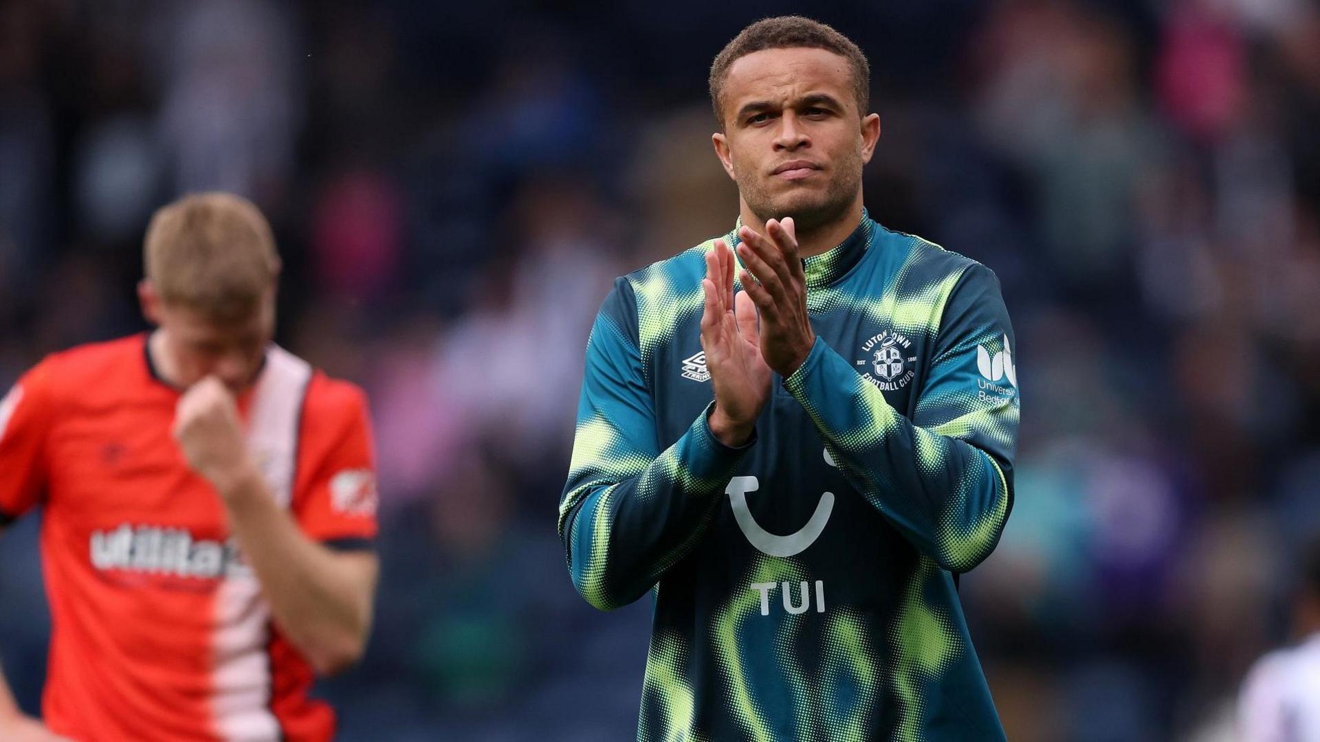 Carlton Morris applauds the Luton supporters