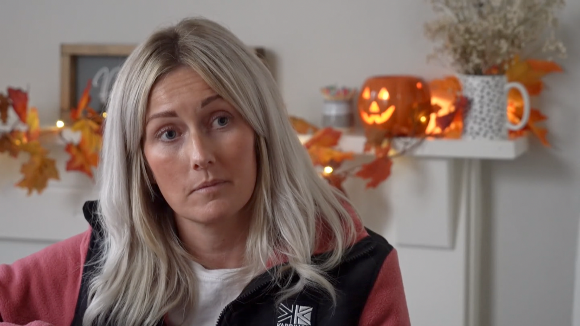 Sophie Underwood Jones with halloween decorations behind her, including a pumpkin lantern