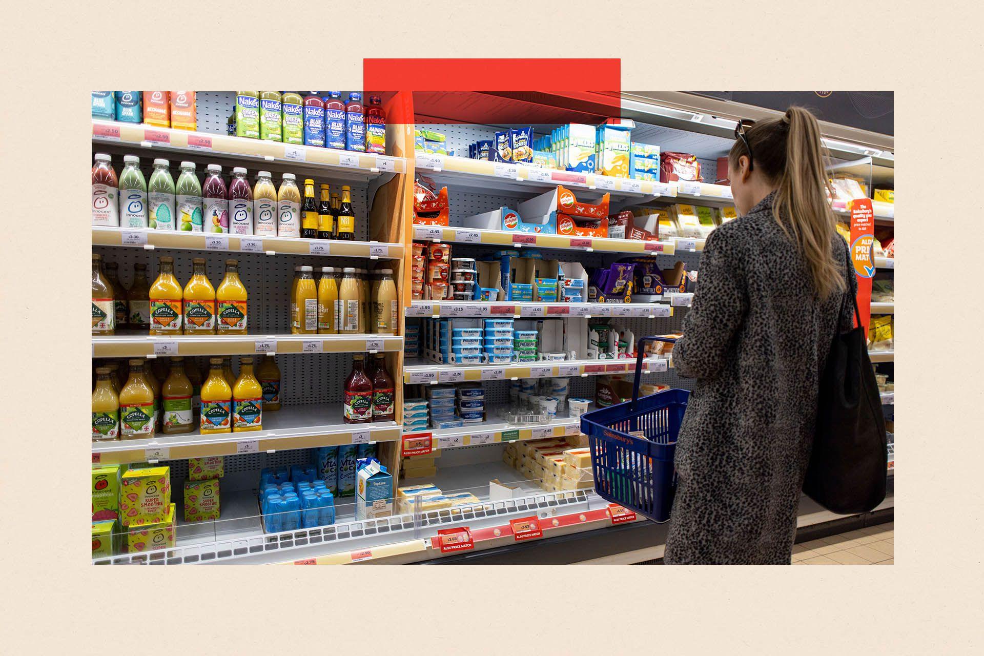 A woman shops at a supermarket, facing rows of orange juice