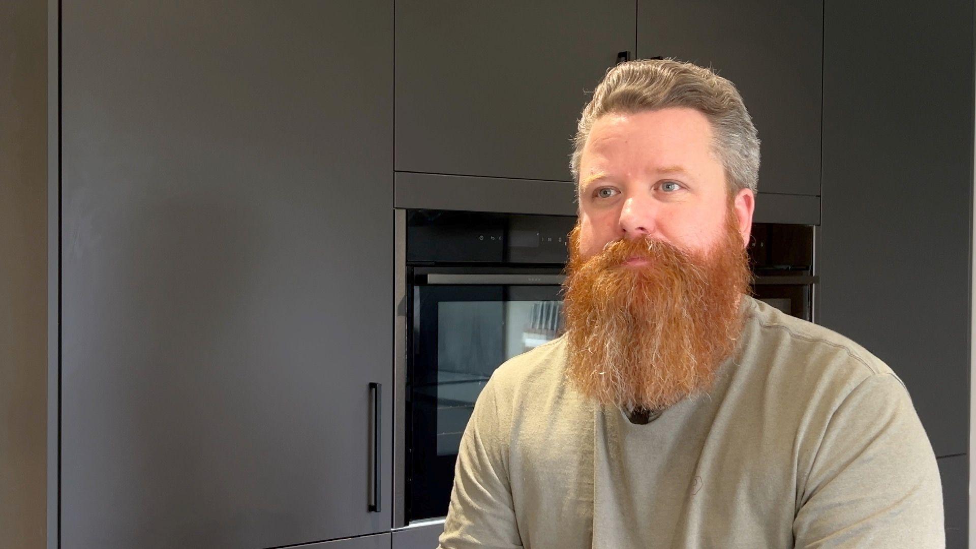 Pete Evans whose son was educated out of school by Remedicare, seated in the family home.