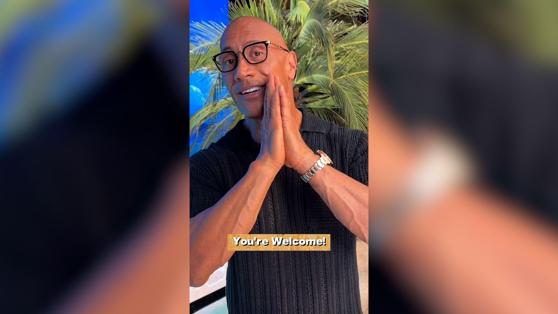 A screenshot of Dwayne Johnson's video to the students. The background is a tropical beach and the caption reads "You're welcome!"
